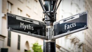 Street sign pointing toward myths and facts